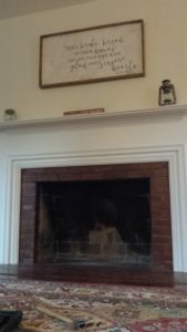 Brick fireplace with ornate wooden mantle