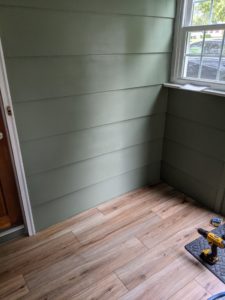 Green wall with LVP flooring before bench installation 