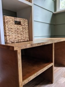 Close up of bench with shoe cubbies and basket for storage