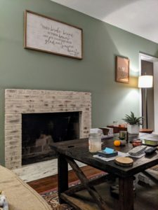 Living room with brick fireplace painted with Romabio Paints Classico Limewash in the color Riposo Beige